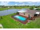 Aerial view of home, pool, and surrounding landscape at 76 Caddy Rd, Rotonda West, FL 33947