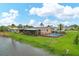 Home with private pool, screened patio, and canal-front view at 76 Caddy Rd, Rotonda West, FL 33947