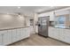 Modern kitchen with white cabinets, granite counters, and stainless steel appliances at 76 Caddy Rd, Rotonda West, FL 33947