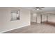 Open living room with kitchen pass-through and neutral-toned laminate flooring at 76 Caddy Rd, Rotonda West, FL 33947