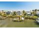 Aerial view of waterfront home with private dock and boat slips at 13330 Anglers Way, Placida, FL 33946