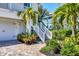 Exterior stairs leading up to the home from the driveway at 13330 Anglers Way, Placida, FL 33946