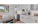 White kitchen with granite counters and stainless steel appliances at 13330 Anglers Way, Placida, FL 33946