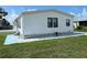 White mobile home with landscaped yard at 8485 Nighthawk Dr, Englewood, FL 34224