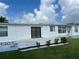 White mobile home with patio and landscaping at 8485 Nighthawk Dr, Englewood, FL 34224