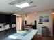 Spacious kitchen with dark cabinetry, a kitchen island and ample counter space at 8485 Nighthawk Dr, Englewood, FL 34224