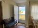 Front entry with a bench and door leading outside at 8485 Nighthawk Dr, Englewood, FL 34224