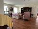 Living room with floral couch and wood flooring at 8485 Nighthawk Dr, Englewood, FL 34224