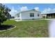 White mobile home with lawn and landscaping at 8485 Nighthawk Dr, Englewood, FL 34224