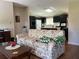 Living room features floral couch and coffee table at 8485 Nighthawk Dr, Englewood, FL 34224