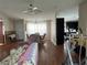 Bright living room with hardwood floors, comfy seating, and a view of the kitchen at 8485 Nighthawk Dr, Englewood, FL 34224