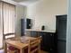 Bright dining area with wood table and black cabinets at 8485 Nighthawk Dr, Englewood, FL 34224