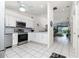 Modern kitchen featuring stainless steel appliances and white cabinetry at 4260 Placida Rd # 9B, Englewood, FL 34224