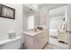 Simple bathroom with a vanity, toilet, and access to bedroom at 4260 Placida Rd # 9B, Englewood, FL 34224