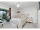 Bright bedroom with a queen-size bed, and access to a private balcony at 4260 Placida Rd # 9B, Englewood, FL 34224