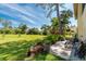 Relaxing patio with seating area, lush landscaping, and spacious lawn at 4260 Placida Rd # 9B, Englewood, FL 34224