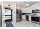 Modern kitchen with stainless steel appliances and view to entrance at 4260 Placida Rd # 9B, Englewood, FL 34224