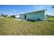 Large backyard with grassy area and patio at 13478 Santa Rosa Ave, Port Charlotte, FL 33981