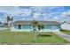 Light teal single story home with a two car garage at 13478 Santa Rosa Ave, Port Charlotte, FL 33981