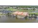 Aerial view of community tennis courts near a pond at 13478 Santa Rosa Ave, Port Charlotte, FL 33981