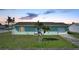 Single story home with a two car garage and palm trees at 13478 Santa Rosa Ave, Port Charlotte, FL 33981