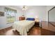 Cozy bedroom with a full-size bed and wood floors at 13478 Santa Rosa Ave, Port Charlotte, FL 33981