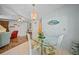 Bright dining room with glass table and chairs, view to living room at 13478 Santa Rosa Ave, Port Charlotte, FL 33981