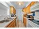 Galley kitchen with wood cabinets, ample counter space, and appliances at 13478 Santa Rosa Ave, Port Charlotte, FL 33981