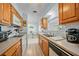 Kitchen with wood cabinets, view to dining area and backyard at 13478 Santa Rosa Ave, Port Charlotte, FL 33981