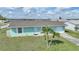 Single-story home with a two-car garage and palm trees at 13478 Santa Rosa Ave, Port Charlotte, FL 33981