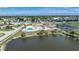 Aerial view of community pool, clubhouse, and surrounding landscape at 13478 Santa Rosa Ave, Port Charlotte, FL 33981