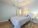 Blue bedroom with a double bed, tile floors, and ceiling fan at 13468 Romford Ave, Port Charlotte, FL 33981