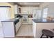 Bright kitchen with white cabinets, stainless steel appliances, and a breakfast bar at 13468 Romford Ave, Port Charlotte, FL 33981