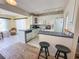 Bright kitchen with white cabinets, stainless steel appliances, and a breakfast bar at 13468 Romford Ave, Port Charlotte, FL 33981
