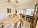 Charming dining room with floral tablecloth and seating for six at 9600 Fiddlers Green Cir # 212, Rotonda West, FL 33947