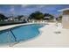 Community swimming pool with surrounding lounge chairs at 9600 Fiddlers Green Cir # 212, Rotonda West, FL 33947