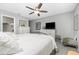Bright bedroom featuring a king-size bed and built-in dresser at 6796 Gasparilla Pines Blvd # 95, Englewood, FL 34224