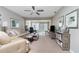 Spacious living room with comfortable seating and access to a sunroom at 6796 Gasparilla Pines Blvd # 95, Englewood, FL 34224