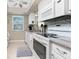 Modern kitchen with white cabinets, granite countertops and stainless steel appliances at 6796 Gasparilla Pines Blvd # 95, Englewood, FL 34224