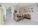 Dining area with wood table and wicker chairs, open to kitchen and living room at 6796 Gasparilla Pines Blvd # 95, Englewood, FL 34224