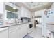 Clean kitchen with white cabinets, granite counters and stainless steel appliances at 6796 Gasparilla Pines Blvd # 95, Englewood, FL 34224