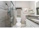 Clean bathroom with a walk-in shower and granite countertop at 6796 Gasparilla Pines Blvd # 95, Englewood, FL 34224