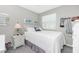 Cozy bedroom with a full-size bed and white dresser at 6796 Gasparilla Pines Blvd # 95, Englewood, FL 34224
