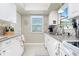 Well-equipped kitchen with white cabinets, granite counters and stainless steel appliances at 6796 Gasparilla Pines Blvd # 95, Englewood, FL 34224