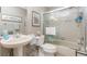 Bathroom with tub shower and pedestal sink at 6796 Gasparilla Pines Blvd # 95, Englewood, FL 34224