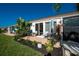 Relaxing patio with outdoor furniture and tropical plants at 6796 Gasparilla Pines Blvd # 95, Englewood, FL 34224
