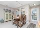 Dining area with a wood table, wicker chairs and view into kitchen at 6796 Gasparilla Pines Blvd # 95, Englewood, FL 34224