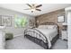 Spacious bedroom with a king-size bed and wood-like wall accents at 6796 Gasparilla Pines Blvd # 95, Englewood, FL 34224