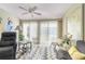 Relaxing sunroom with sliding doors, wicker chairs and ceiling fan at 6796 Gasparilla Pines Blvd # 95, Englewood, FL 34224