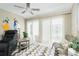 Bright sunroom with sliding glass doors, comfy seating, and ceiling fan at 6796 Gasparilla Pines Blvd # 95, Englewood, FL 34224